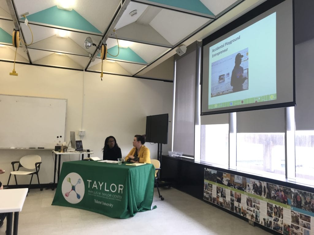 Angela Kyle, accidental playground entrepreneur and director of Playbuild NOLA, sits at a table in a classroom her story at Taylor's Social Innovation Conversation in February 2020.